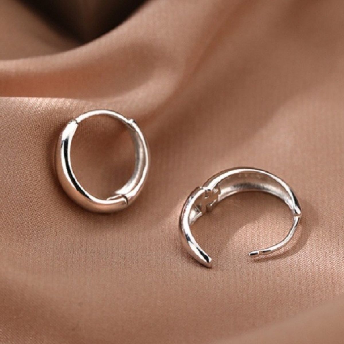 Rounded silver-tone hoop earrings — detail view
