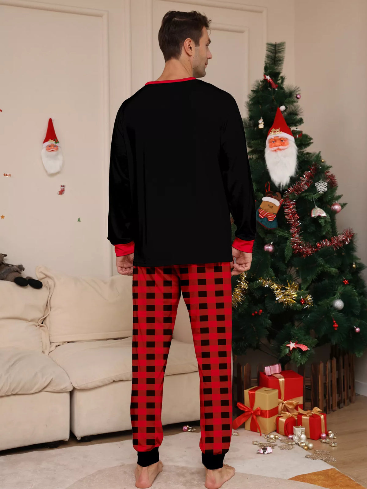 Back view of the men's black top and red plaid pajama pants.