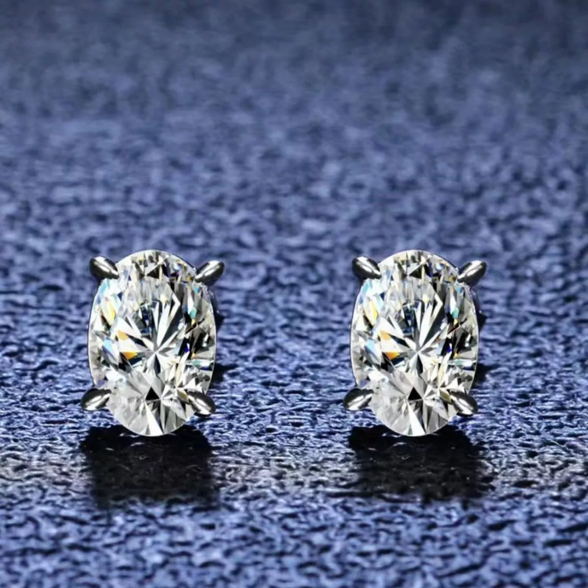 Silver-tone stud earrings with clear faceted stones — detail view