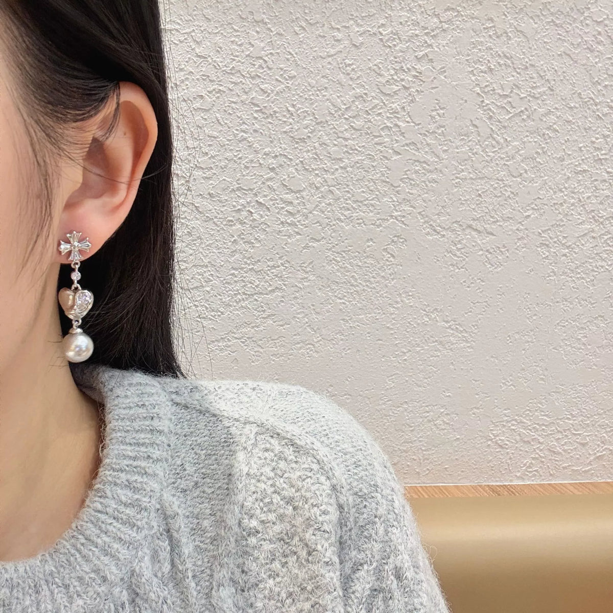 Heart-shaped drop earrings with gray pearl-like beads