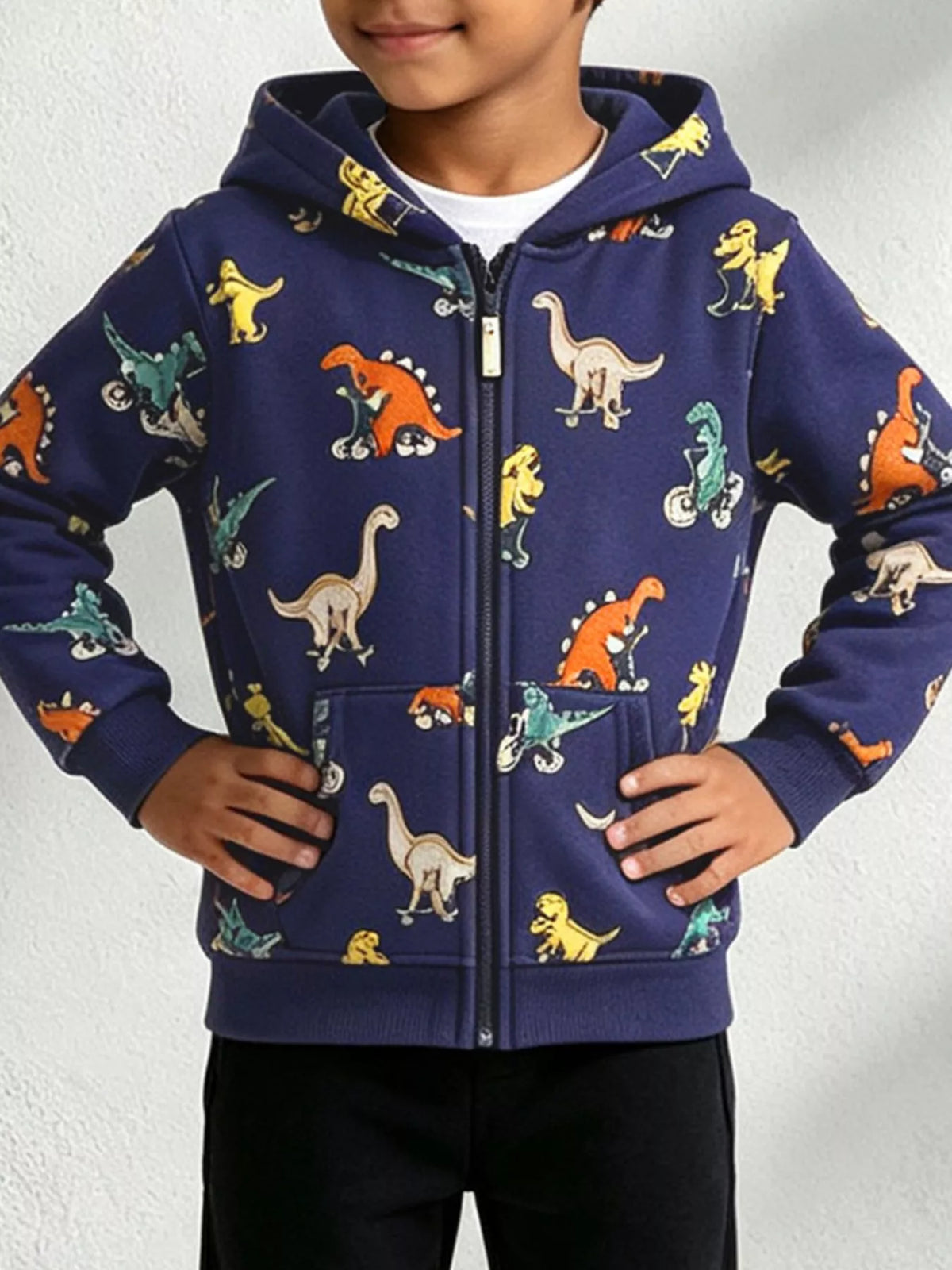 Child wearing a navy zip-up hooded jacket with colorful dinosaur prints.