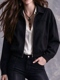 Black collared zip-up bomber jacket modeled over a white top.