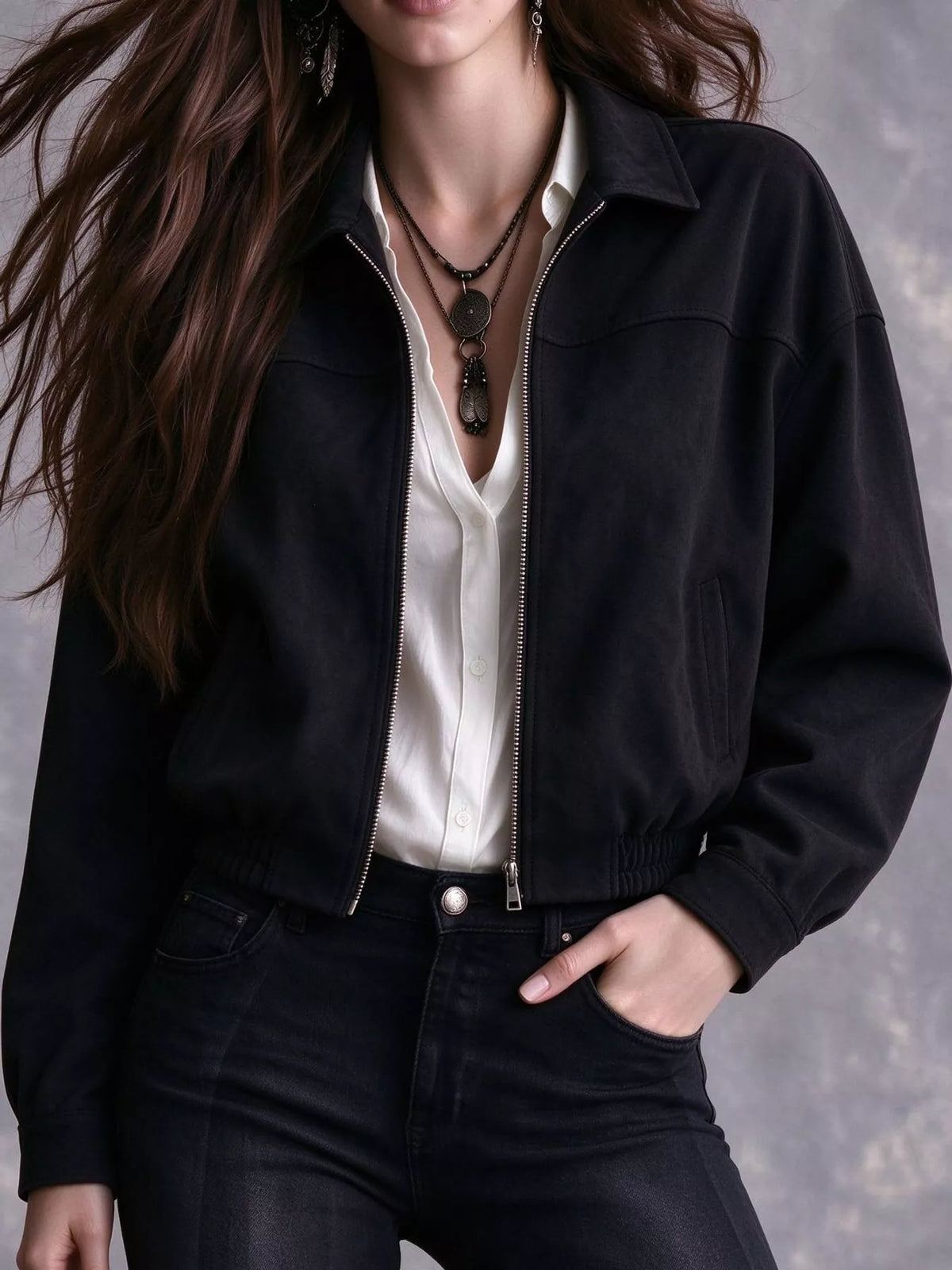 Black collared zip-up bomber jacket modeled over a white top.