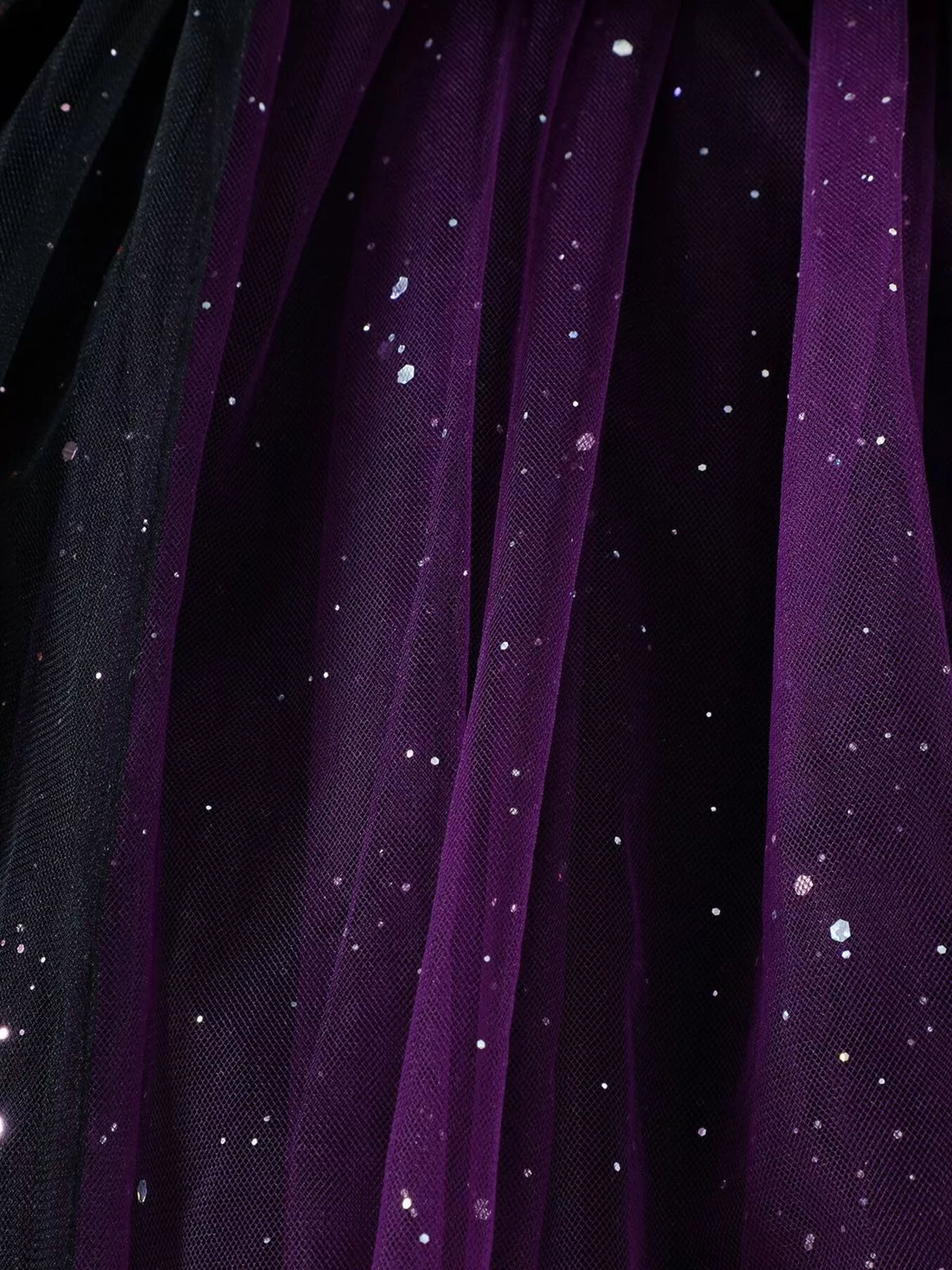 Close-up of black and purple glitter-dotted tulle skirt layers.