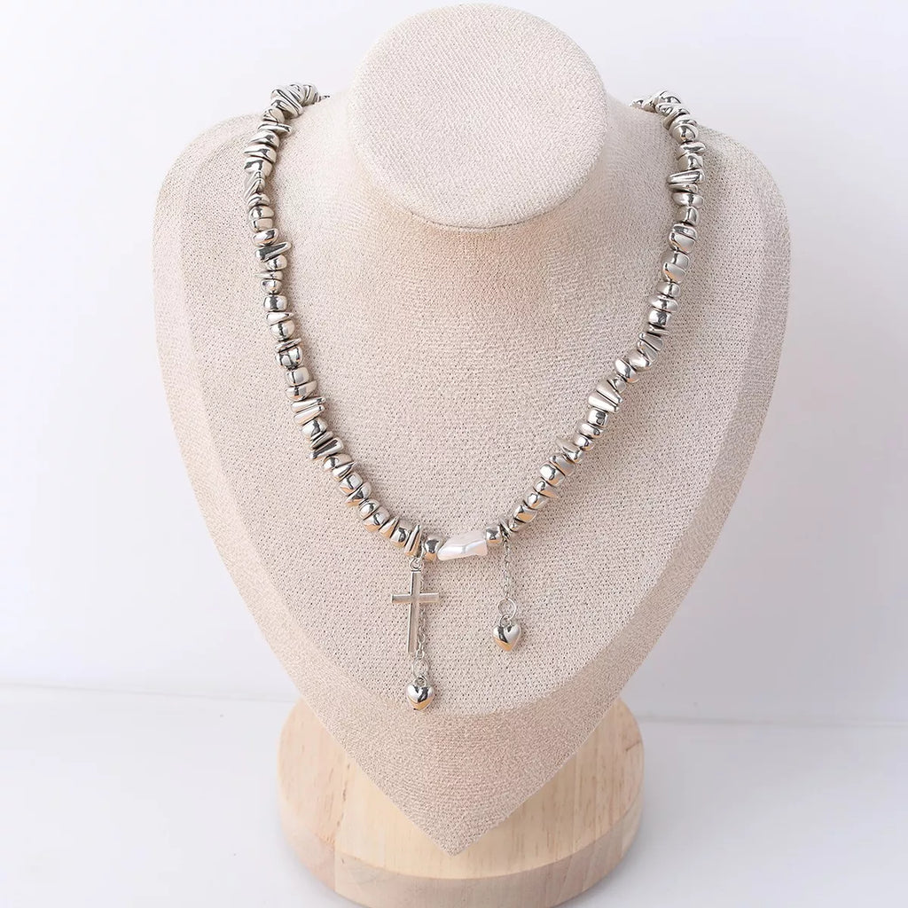 Chunky silver-tone chain necklace with cross and dangling charms