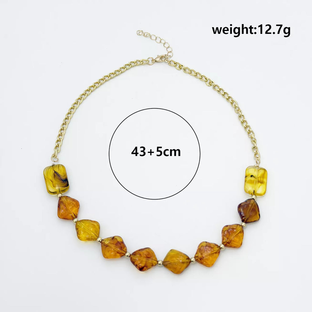 Measurements diagram for gold-tone necklace with angular amber-colored beads