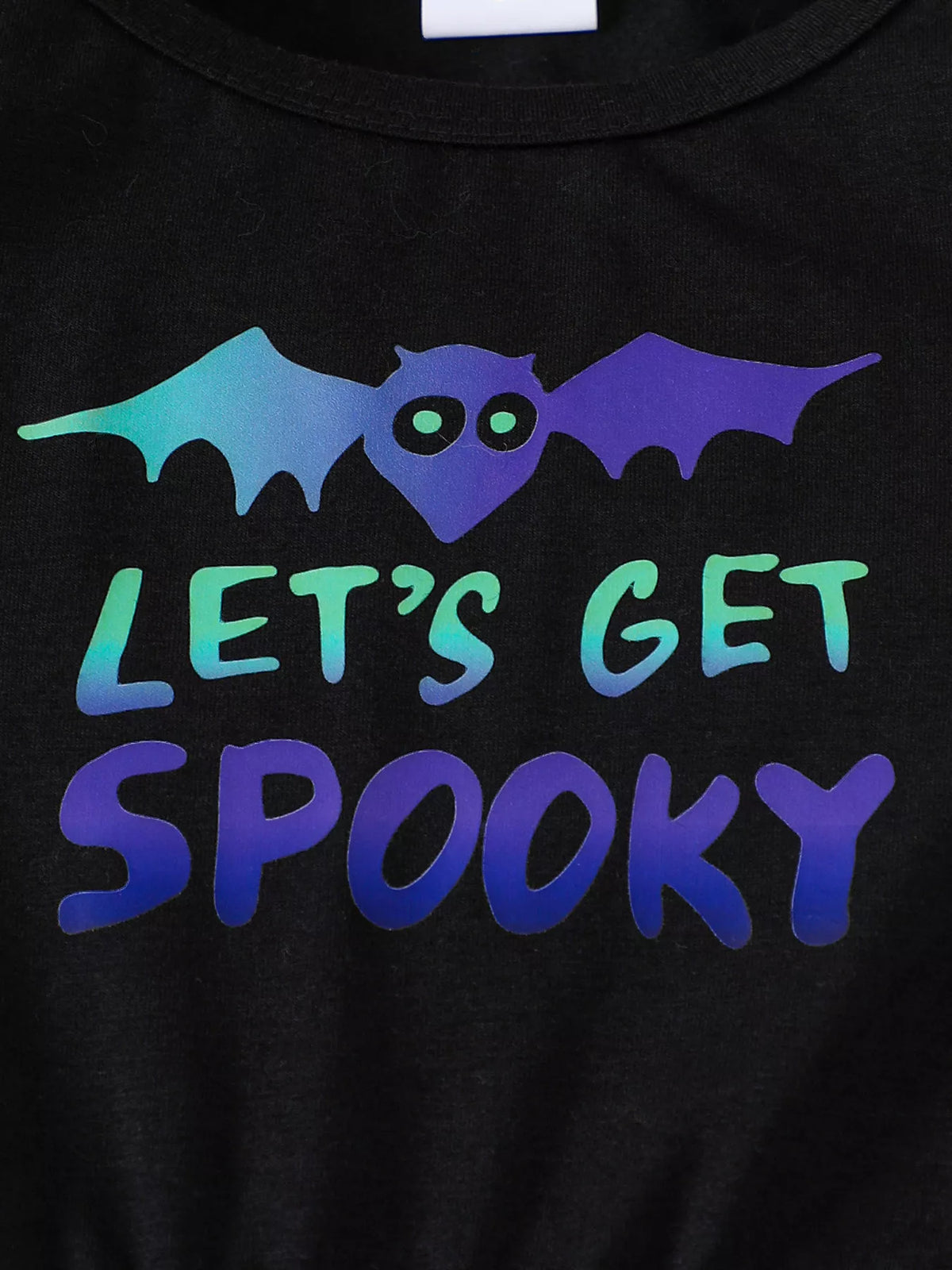Close-up of the multicolor bat and Let's Get Spooky lettering on the black bodice.