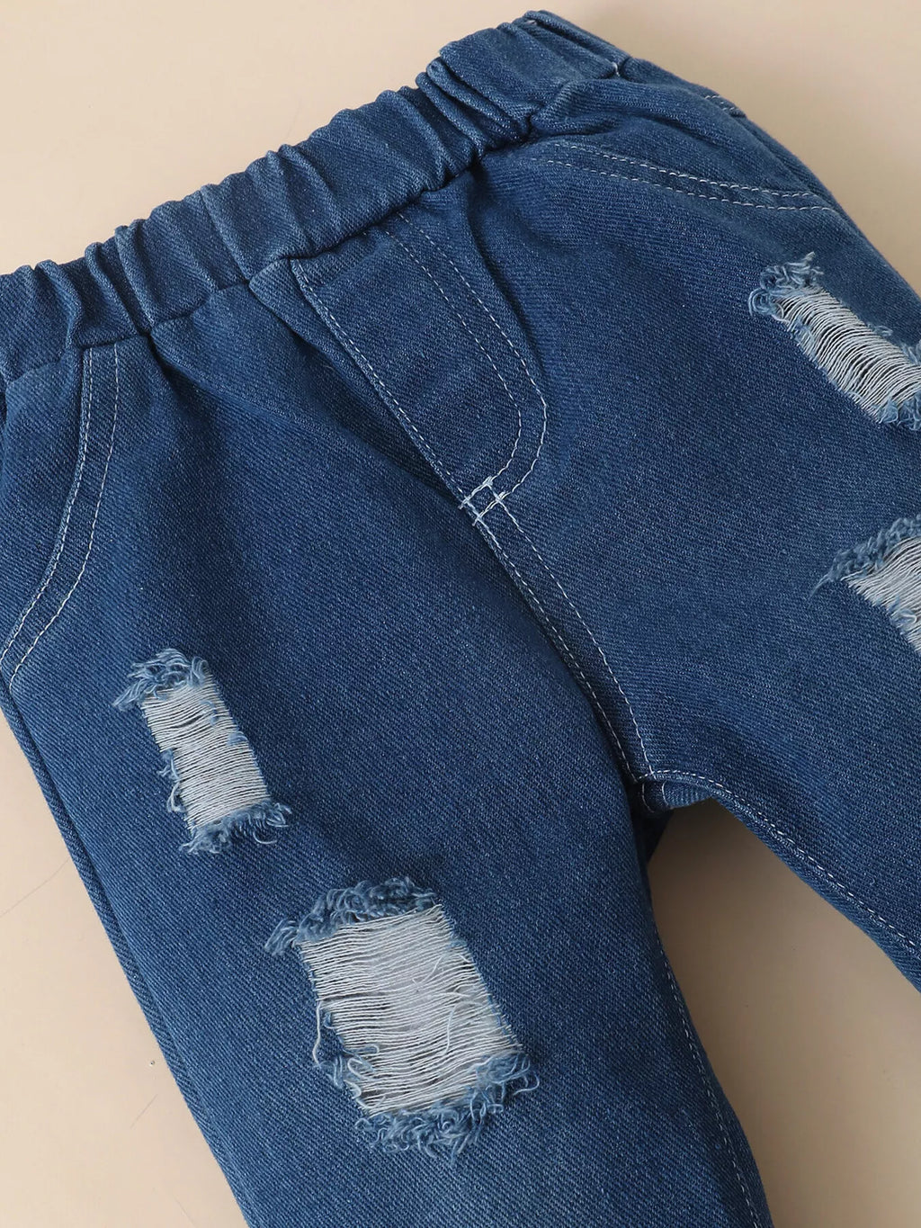 Distressed patch details on the blue jeans