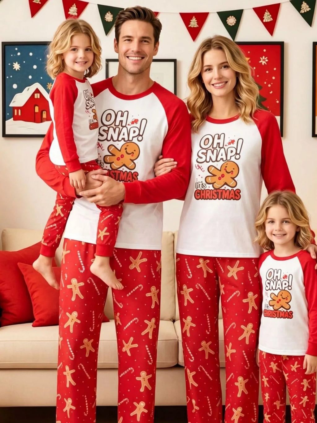 Family wearing matching white Oh Snap gingerbread graphic tops with red sleeves and red printed pajama pants.