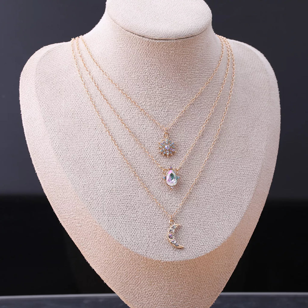 Layered silver-tone necklace with celestial and clear stone charms