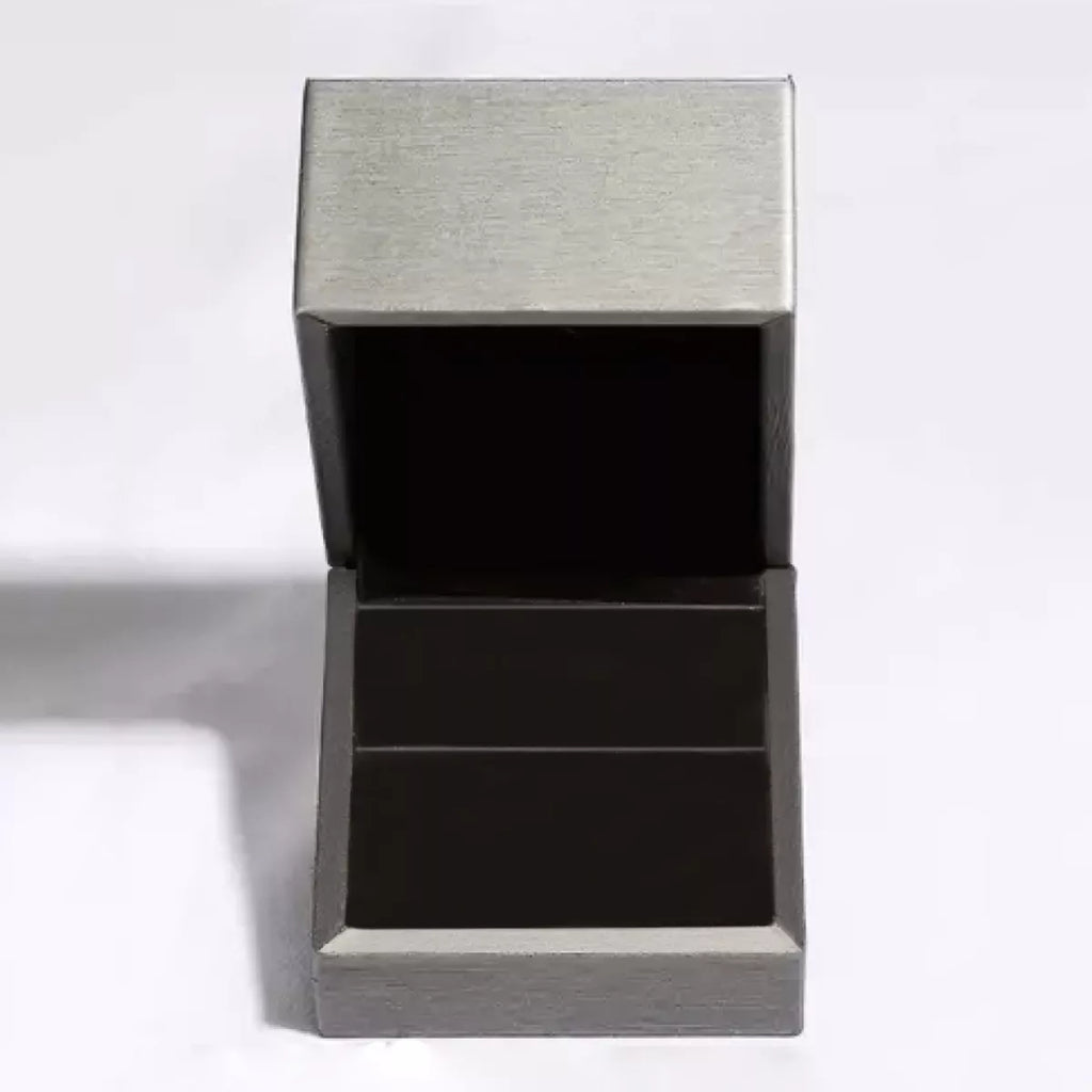 Silver-tone shell-shaped stud earrings with white centers worn on a model
