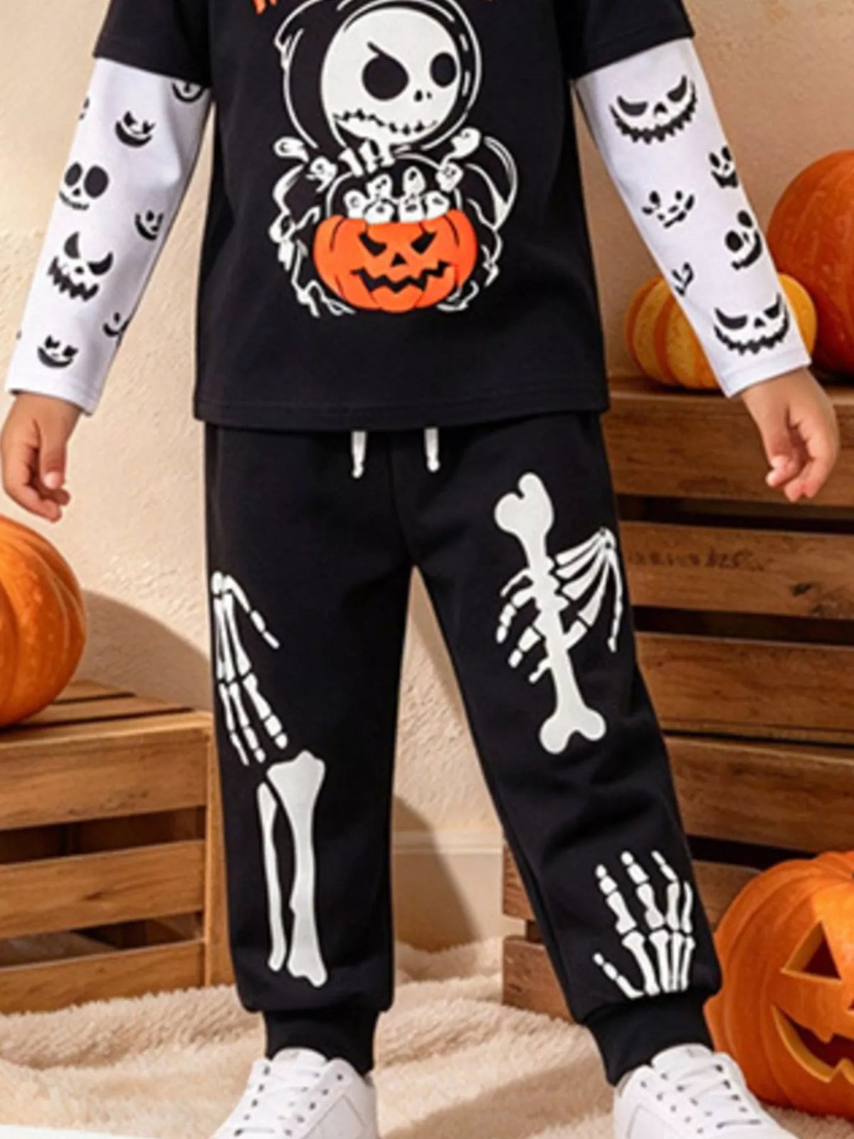 Skeleton and pumpkin graphics on the black Halloween top and pants
