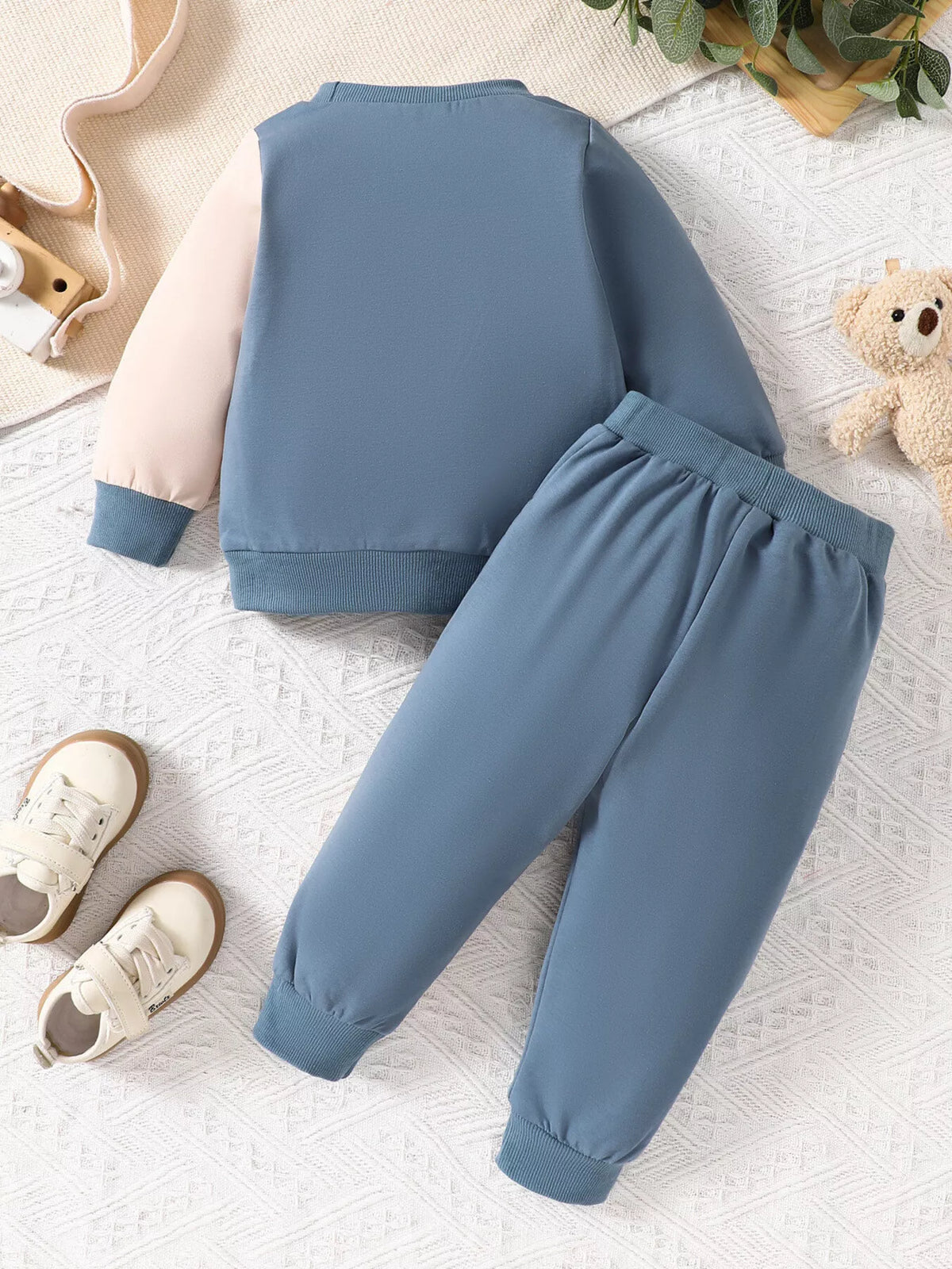 Blue, pink and mint color-block sweatshirt and matching joggers laid flat