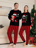Adults wearing matching black Christmas graphic tops with red plaid pants.