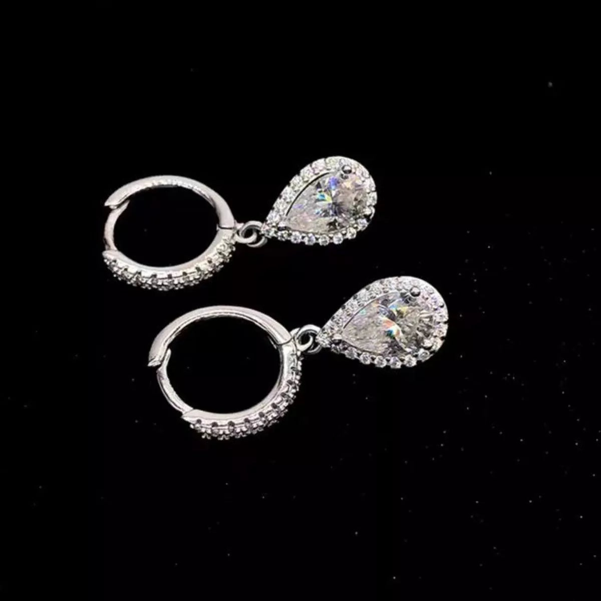 Silver-tone hoop earrings with teardrop halo stone drops — detail view