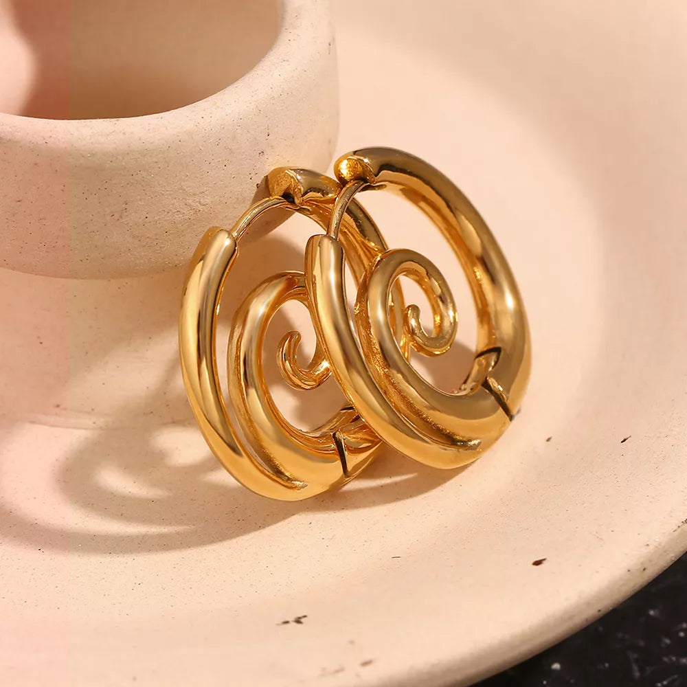 Gold-tone spiral hoop earrings — detail view