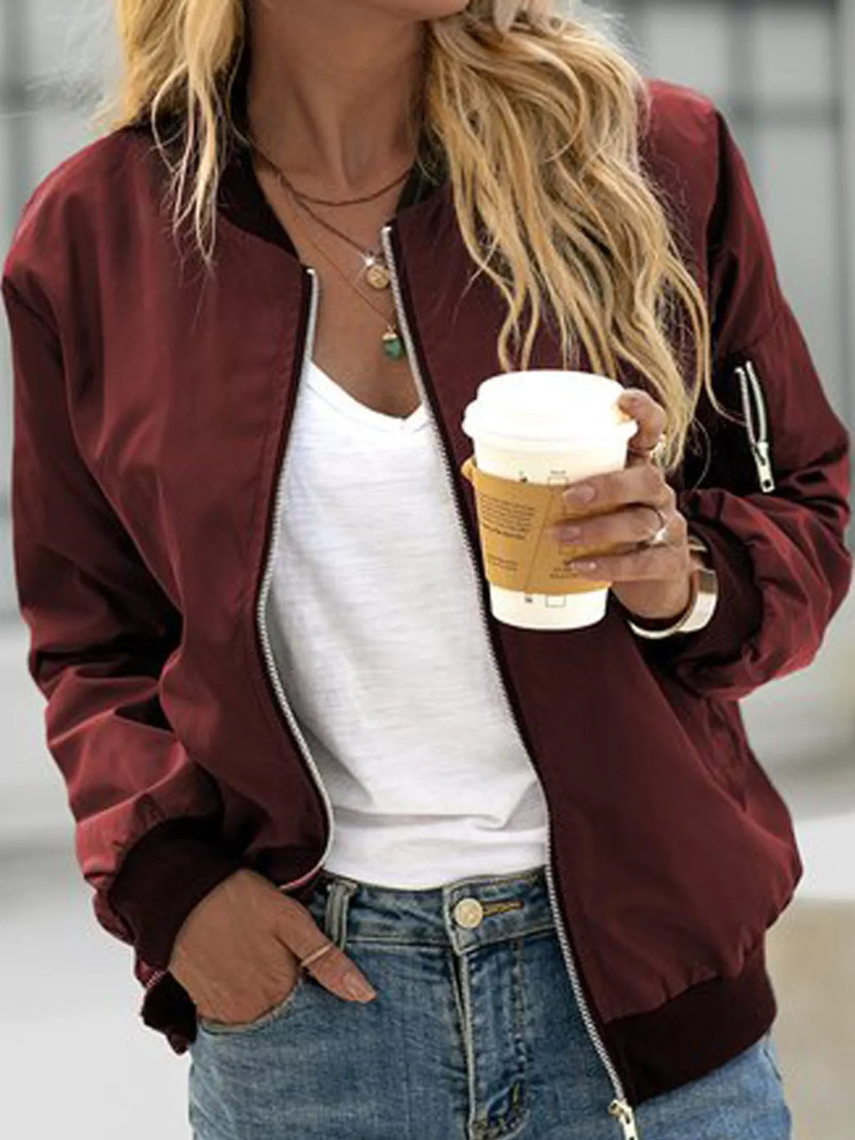Burgundy lightweight bomber jacket modeled with jeans.