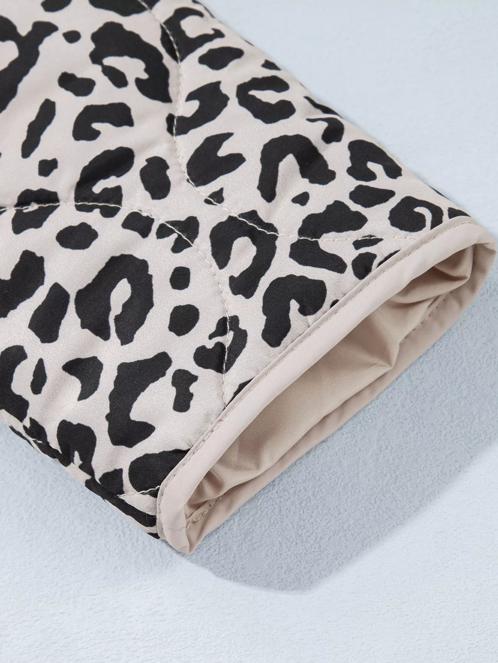 Close-up of the leopard-print jacket's cuff and pale interior.