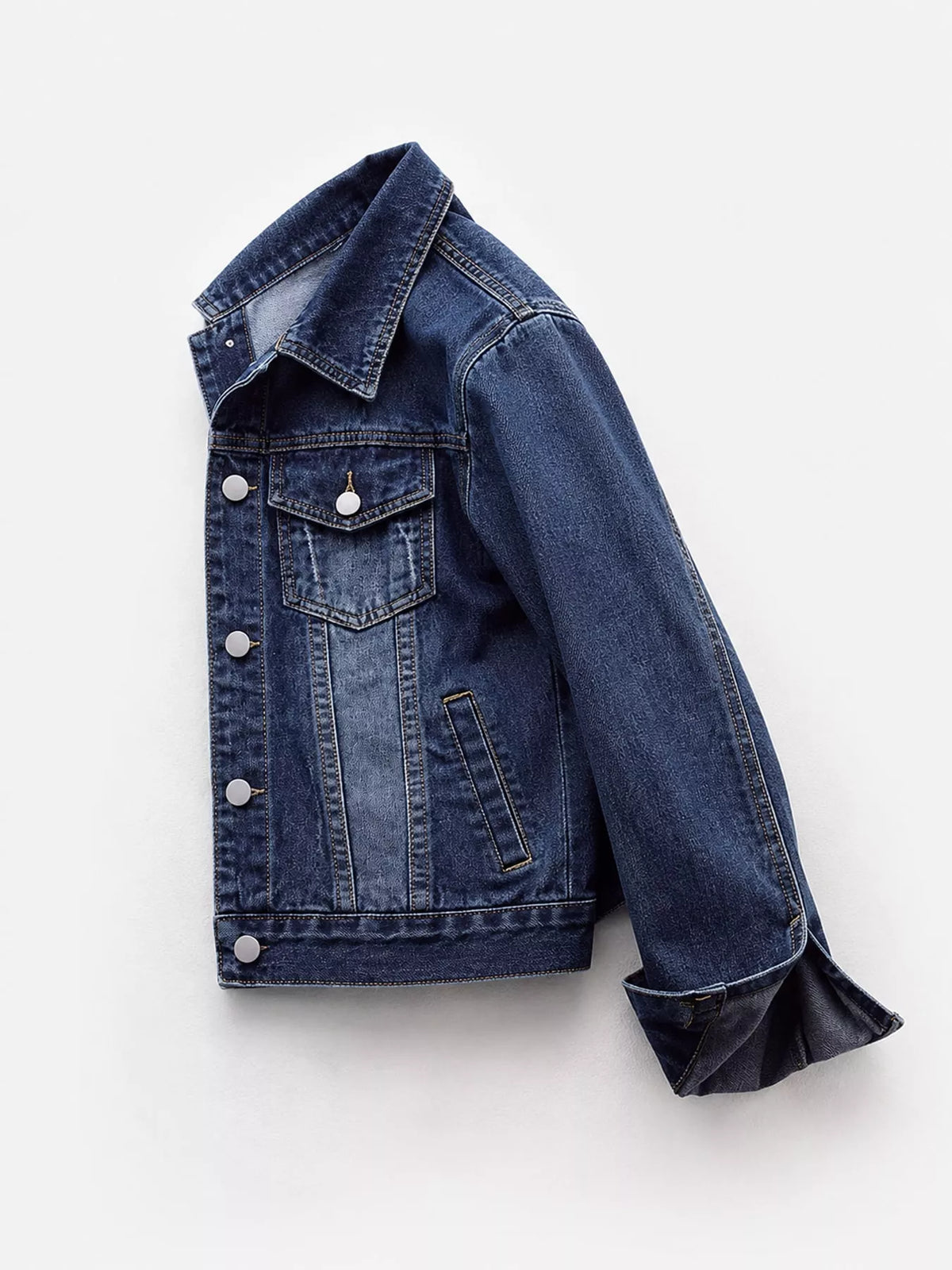 Side view of the medium-wash denim jacket and chest pocket.