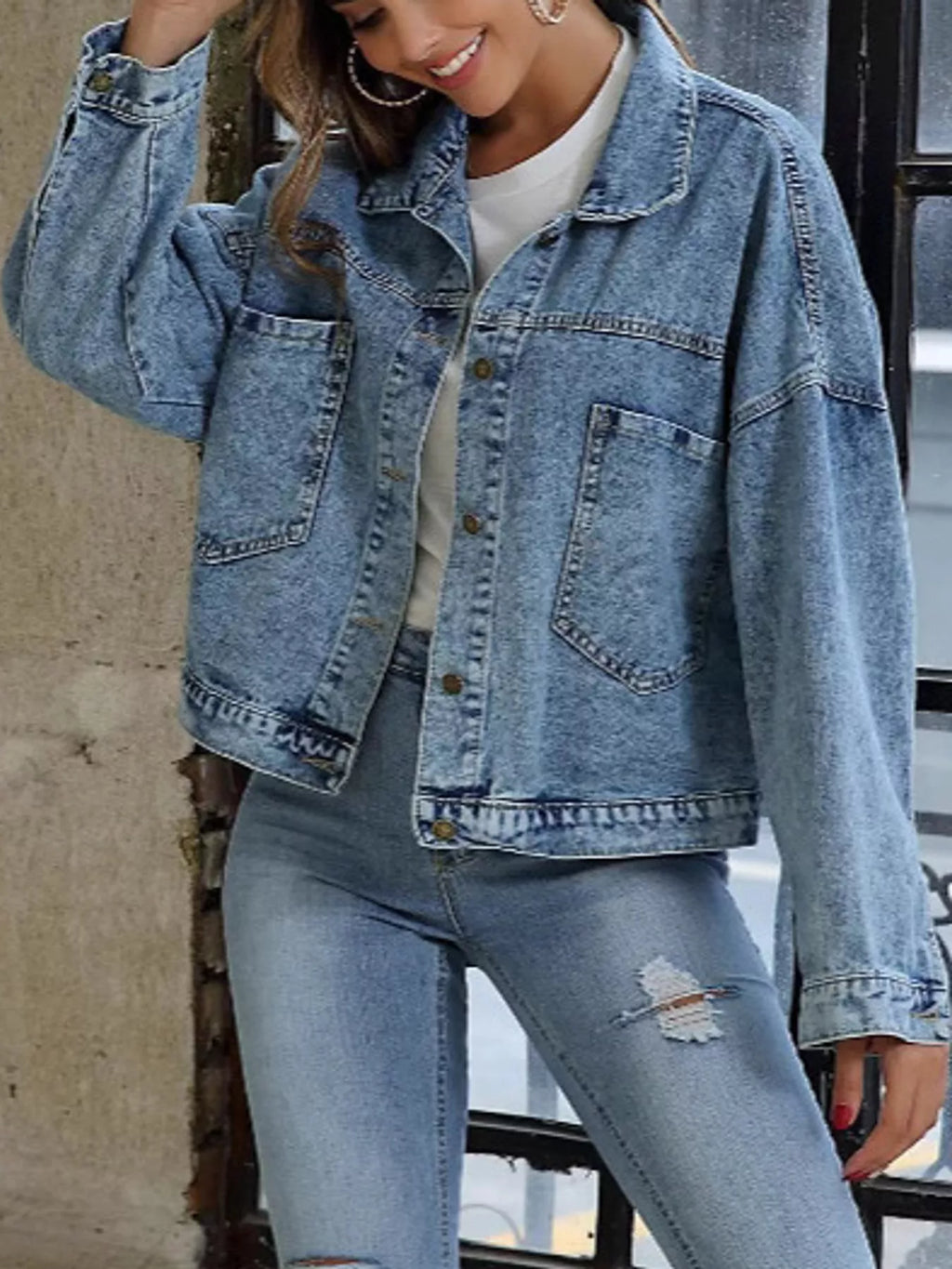 Front view of the light-blue denim jacket's chest pockets and seams.