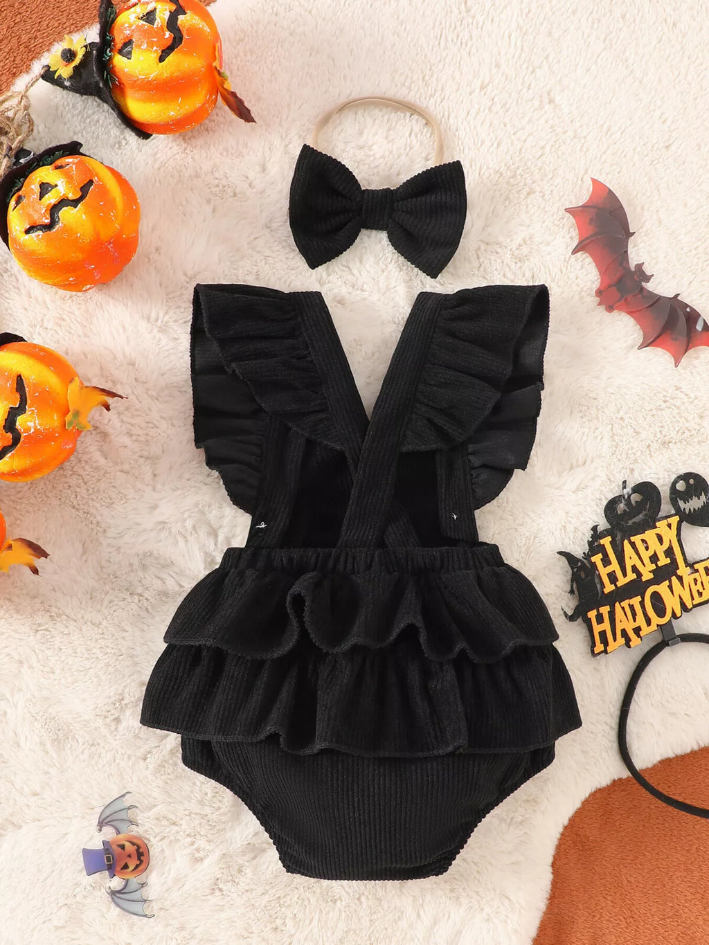 Black skeleton-print ruffle baby bodysuit and matching bow headband — back view