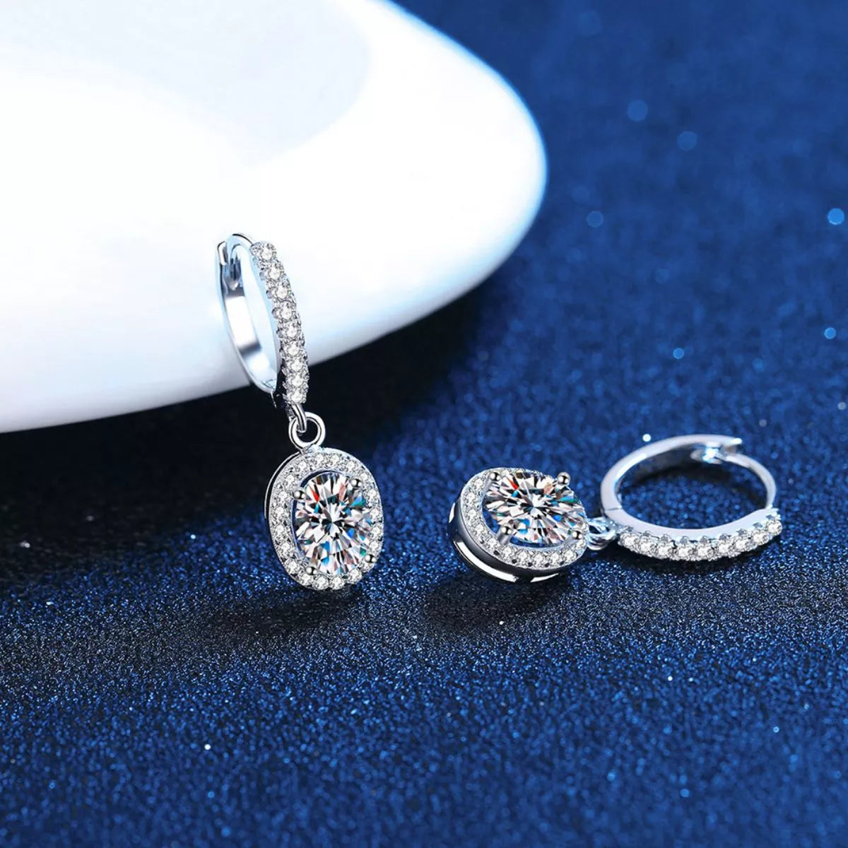 Silver-tone hoop earrings with oval halo stone drops — detail view