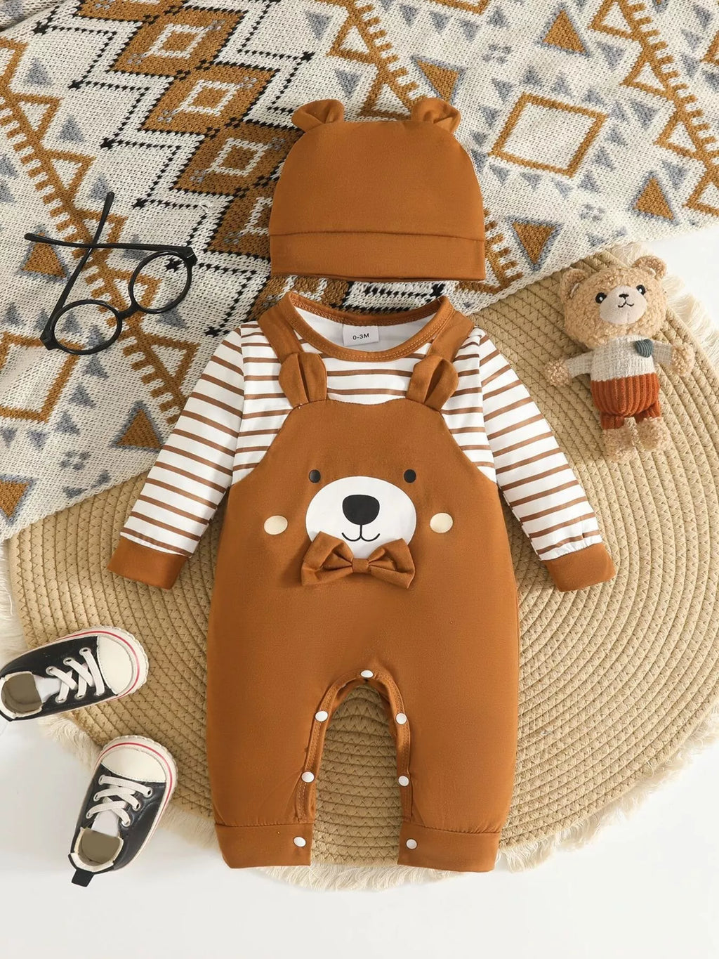 Children’s brown bear-print overalls with striped sleeves and matching hat displayed flat
