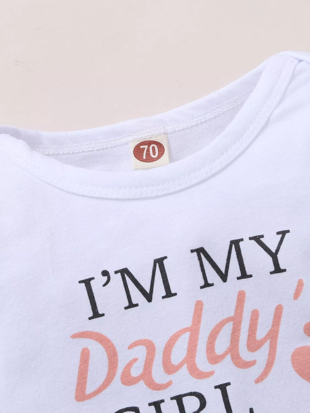 White baby bodysuit neckline and letter graphic