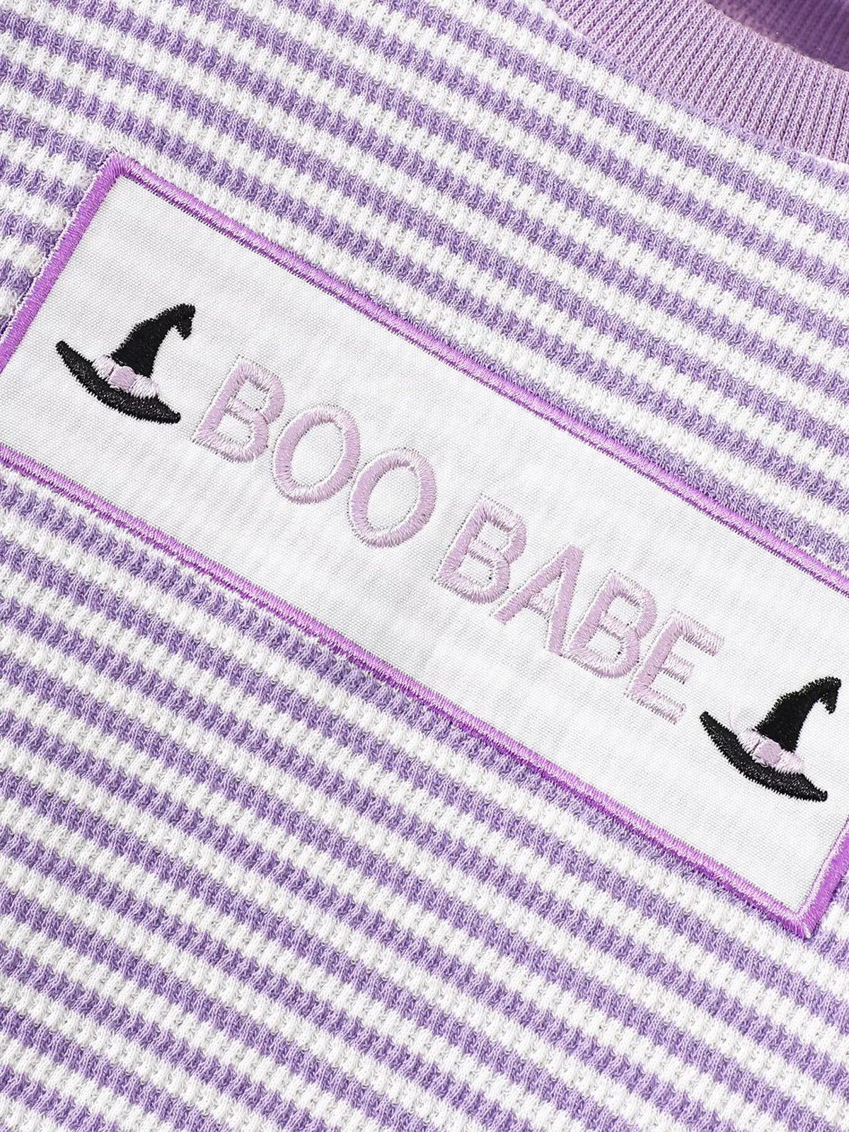 BOO BABE lettering with witch hats on purple-striped pajama fabric