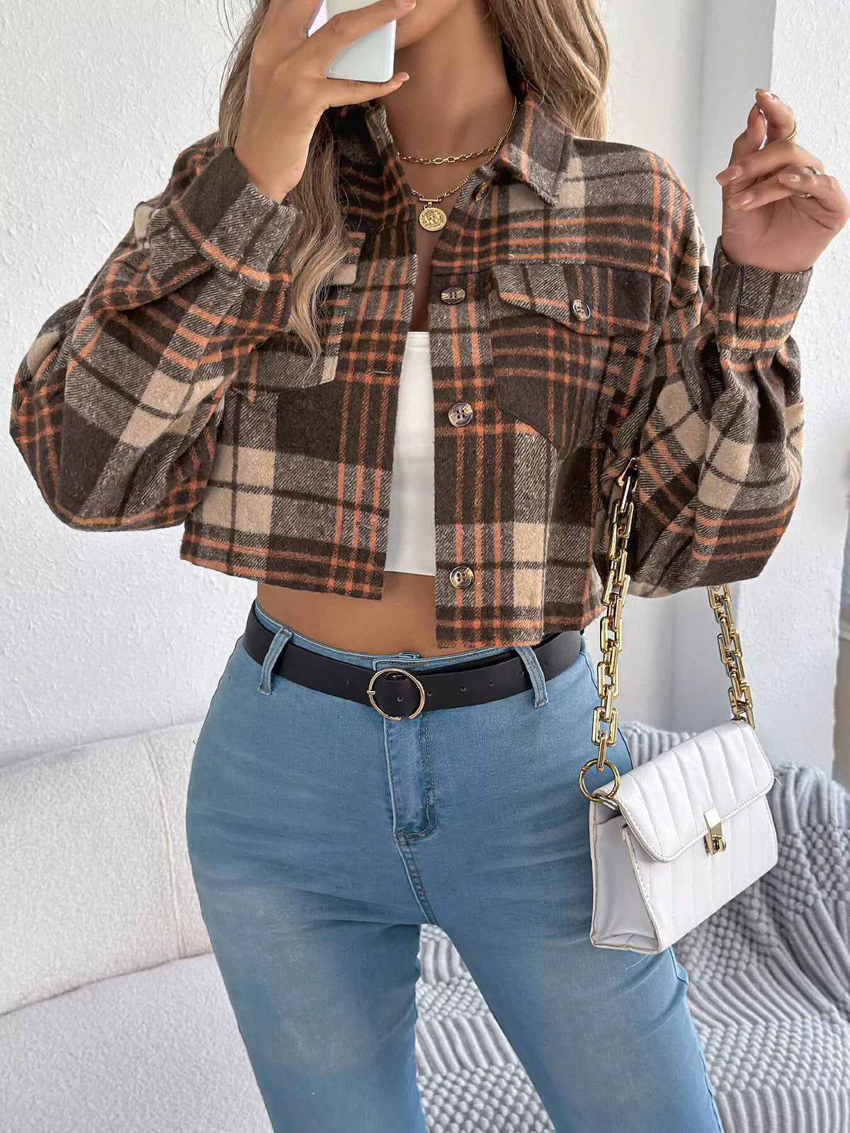Close view of the brown plaid cropped jacket.