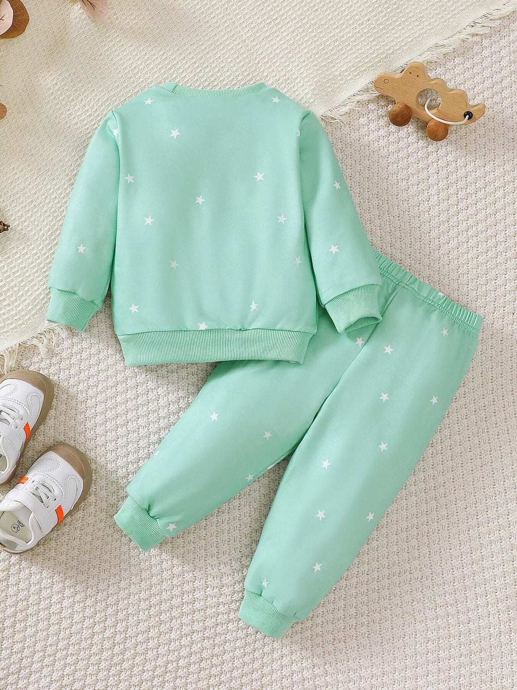 Back flat lay of the mint green star-print sweatshirt and jogger pants.