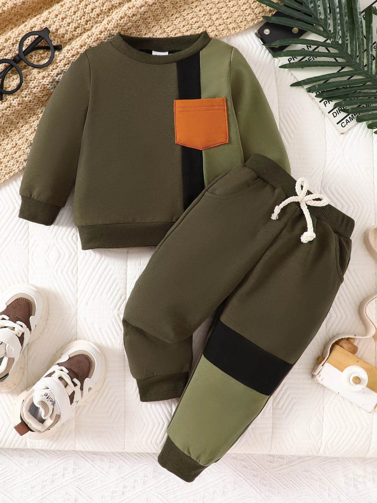 Olive, black and orange color-block sweatshirt and matching joggers laid flat