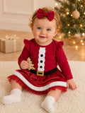 Baby wearing a red Santa-style bodysuit, red skirt with white trim and red bow headband.