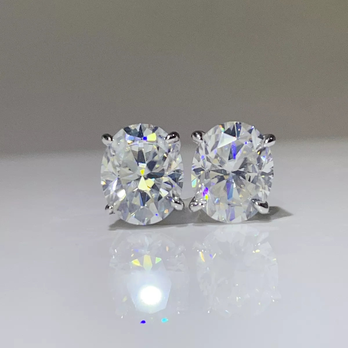 Silver-tone round clear stone stud earrings — detail view
