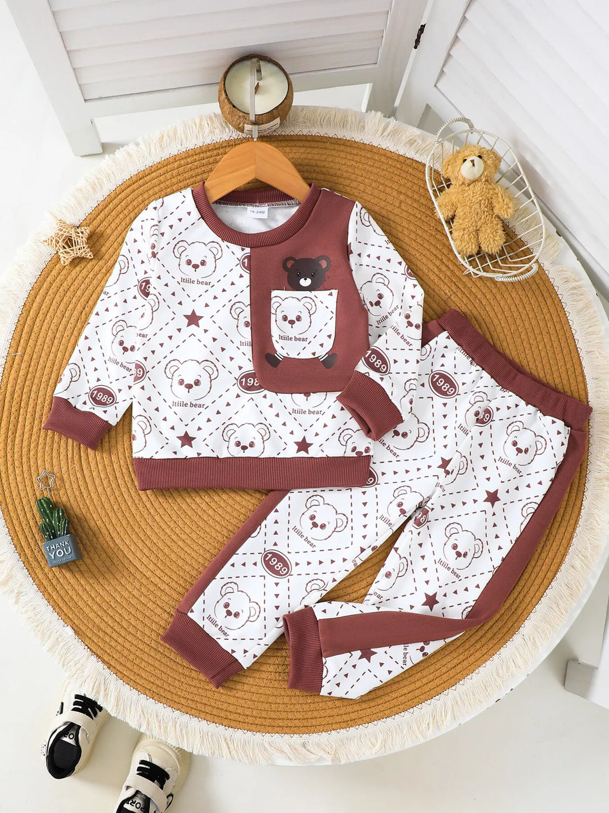 Children’s cream and maroon bear-print sweatshirt and matching pants displayed flat