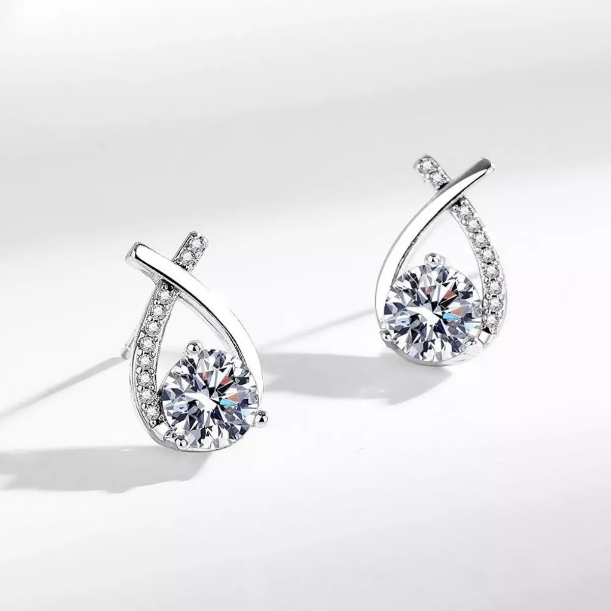 Silver-tone open teardrop earrings with round clear stones — detail view