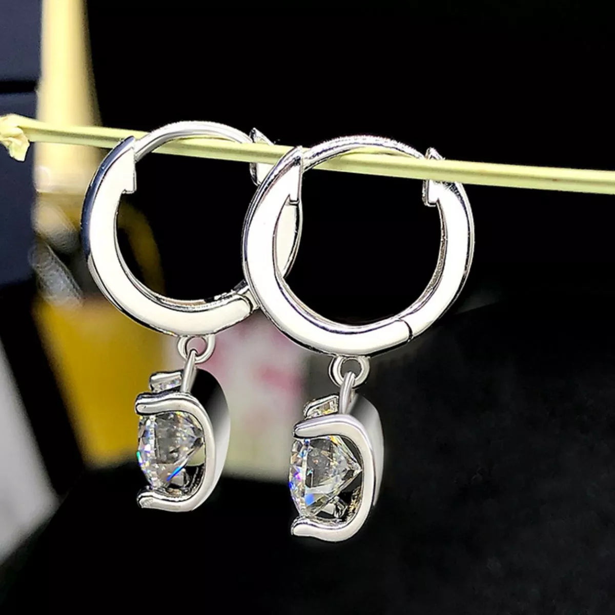 Silver-tone hoop earrings with square clear stone drops — detail view