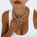 Chunky silver-tone chain necklace with cross and dangling charms