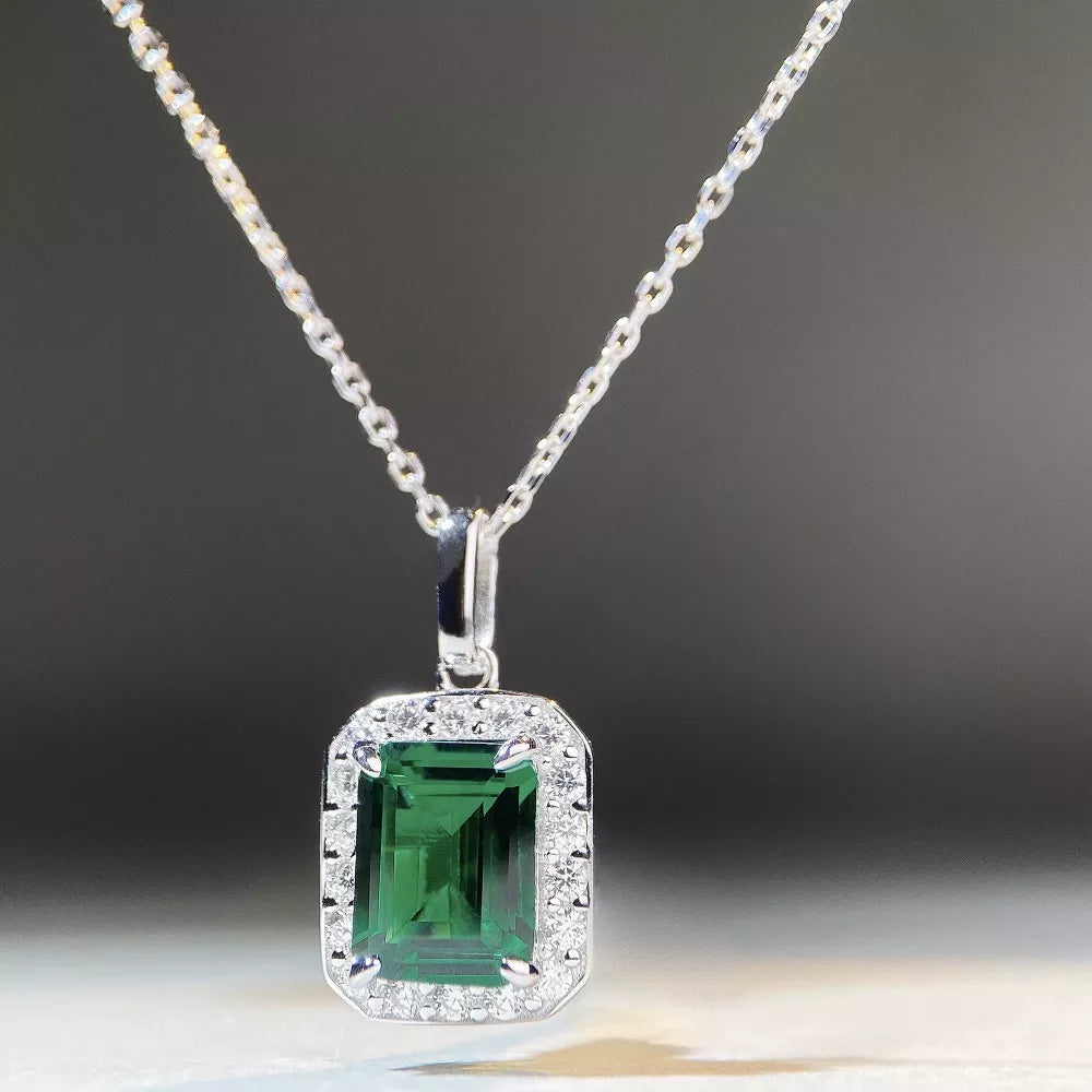 Silver-tone pendant necklace with a green rectangular stone — detail view