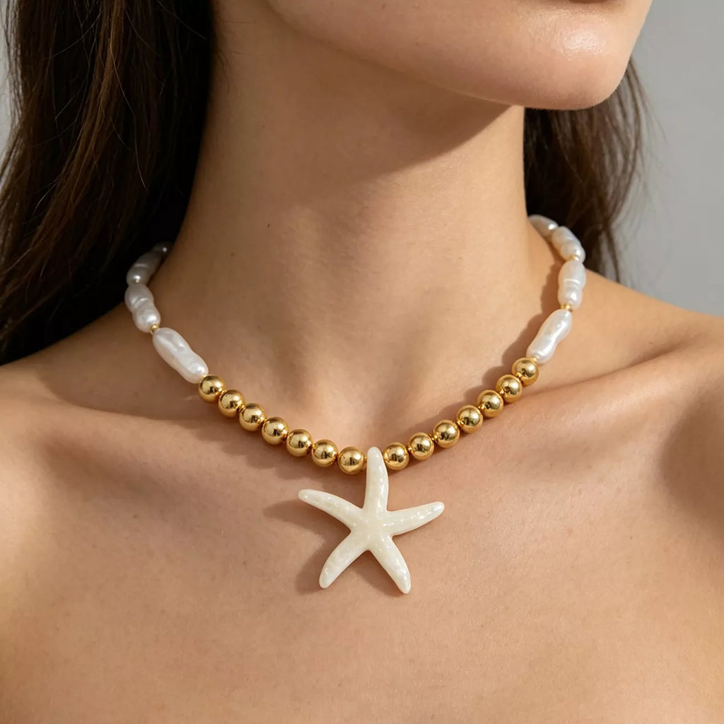 Starfish pendant necklace with gold-tone beads and white shell-like links