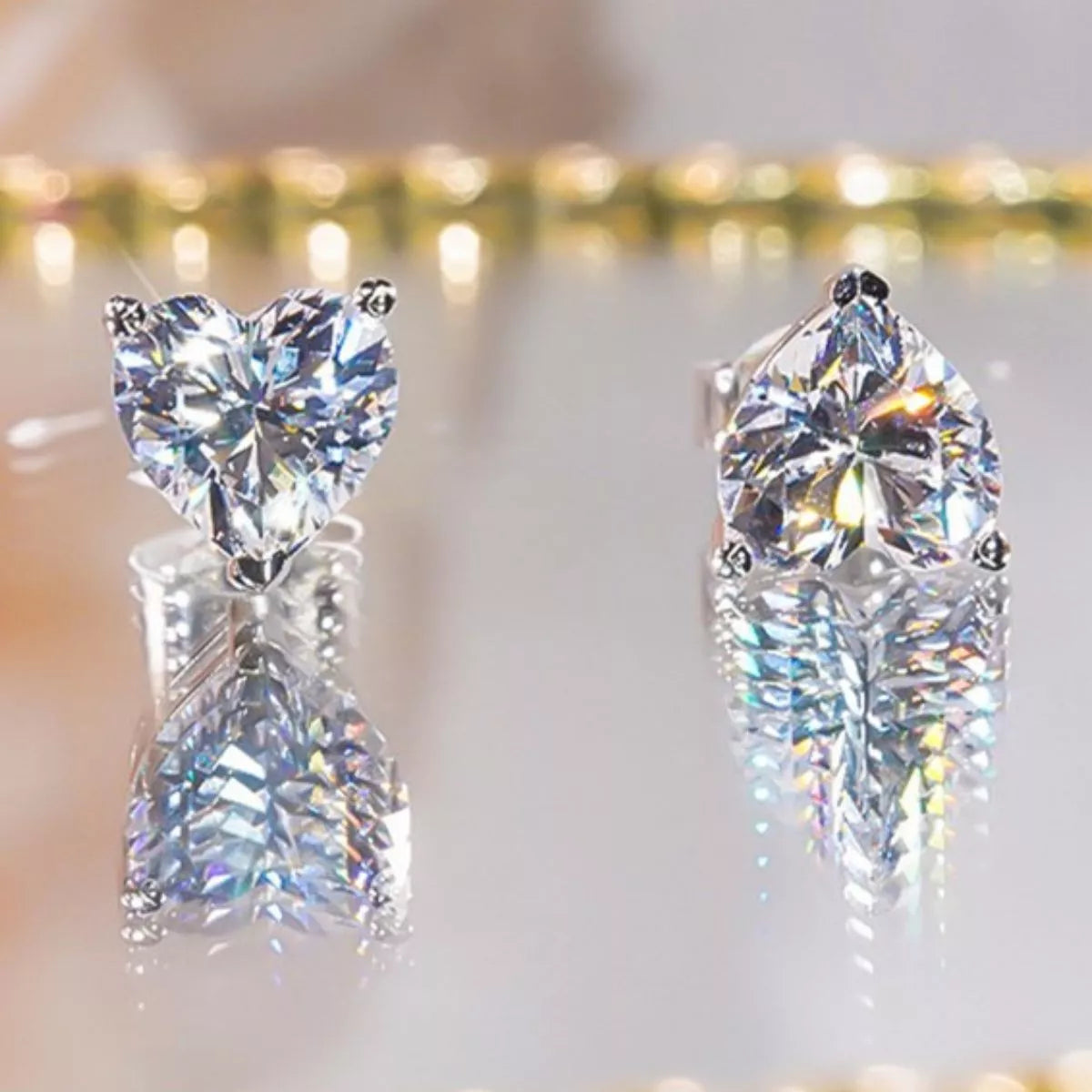 Silver-tone heart-shaped clear stone stud earrings — detail view