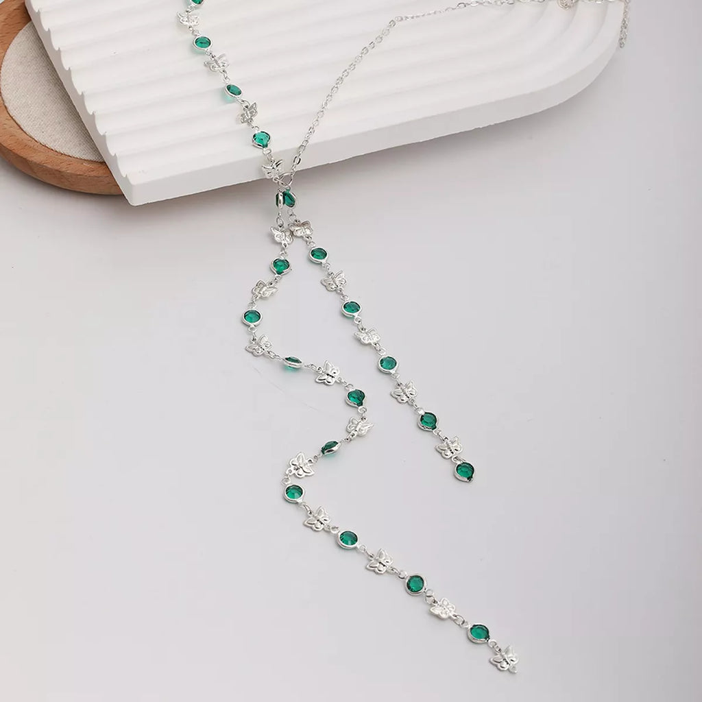 Long silver-tone lariat necklace with butterfly charms and green accents — detail view