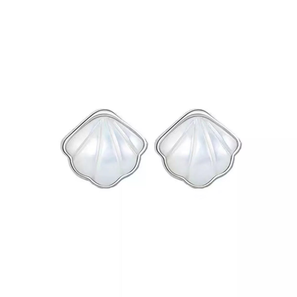 Silver-tone shell-shaped stud earrings with white centers — detail view