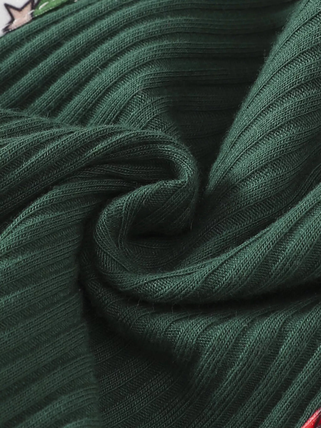 Green ribbed fabric detail on the Santa-print jumpsuit