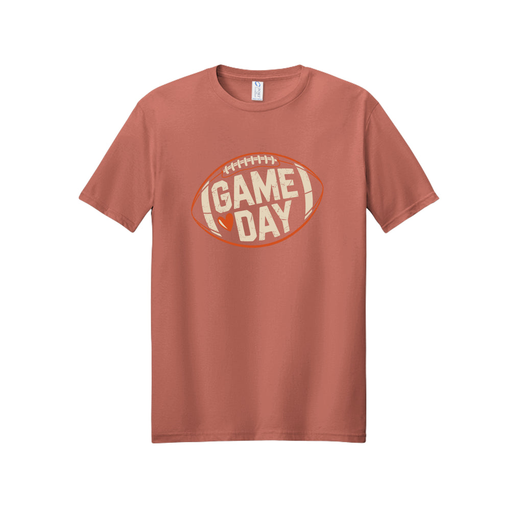 Front view of a dusty rose short-sleeve T-shirt with cream Game Day lettering and a heart inside an orange football outline.