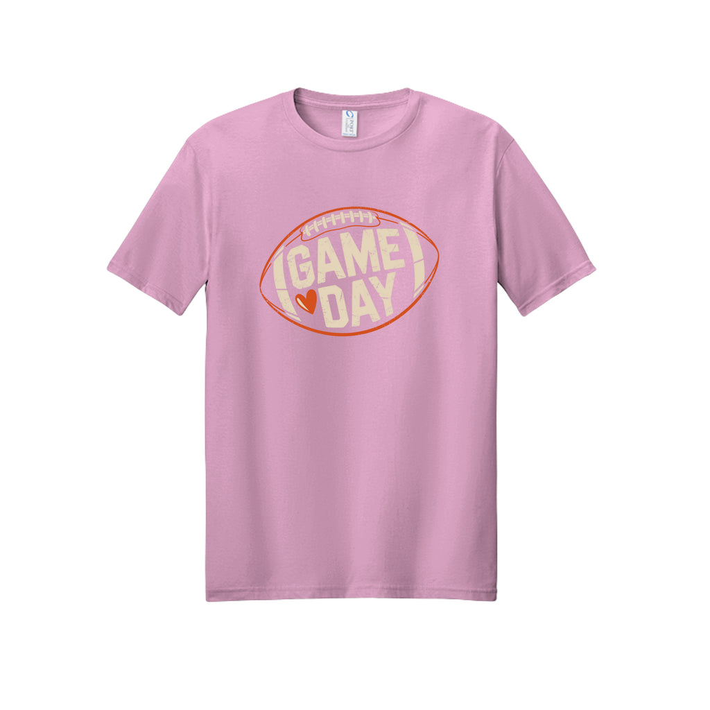 Front view of a light pink short-sleeve T-shirt with cream Game Day lettering and a heart inside an orange football outline.