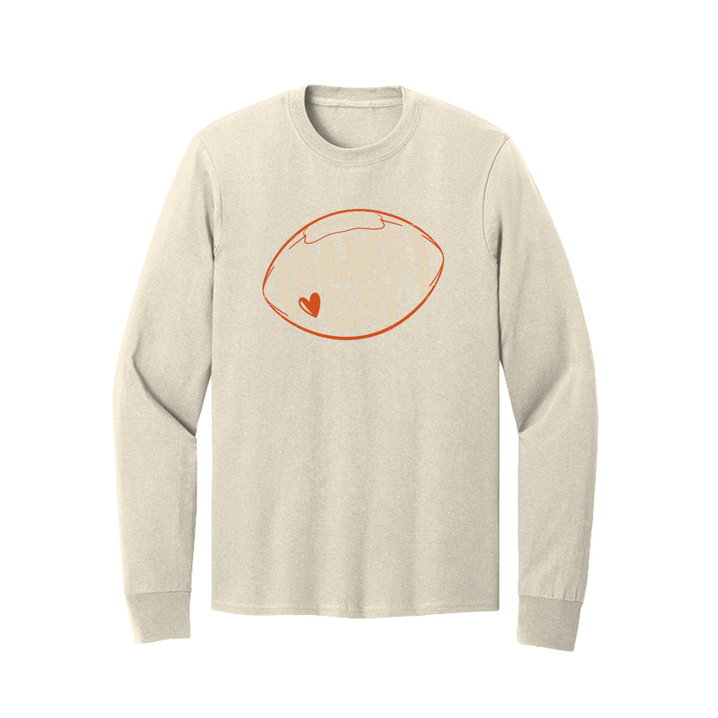 Front view of a cream long-sleeve T-shirt with cream Game Day lettering and a heart inside an orange football outline.