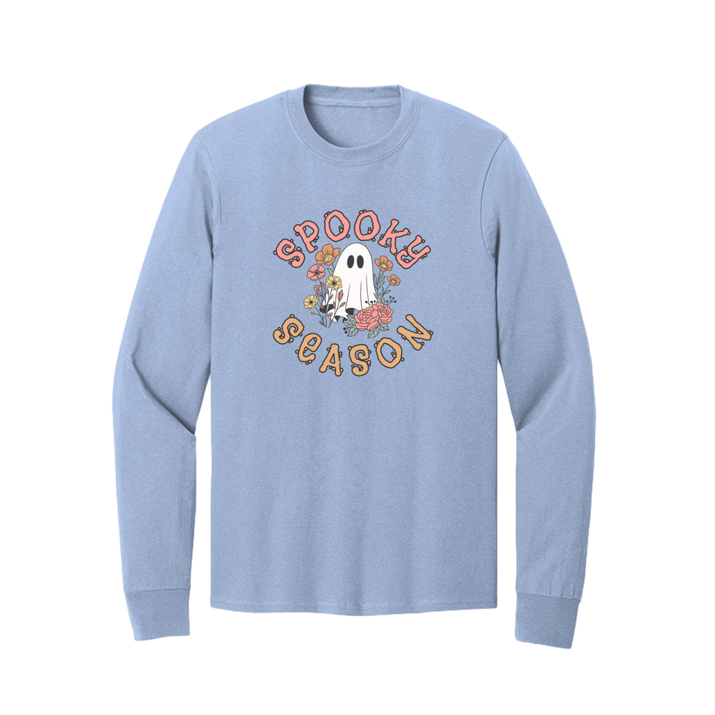 Front view of a light blue long-sleeve T-shirt showing Spooky Season lettering around a white ghost surrounded by pink, orange, and yellow flowers.