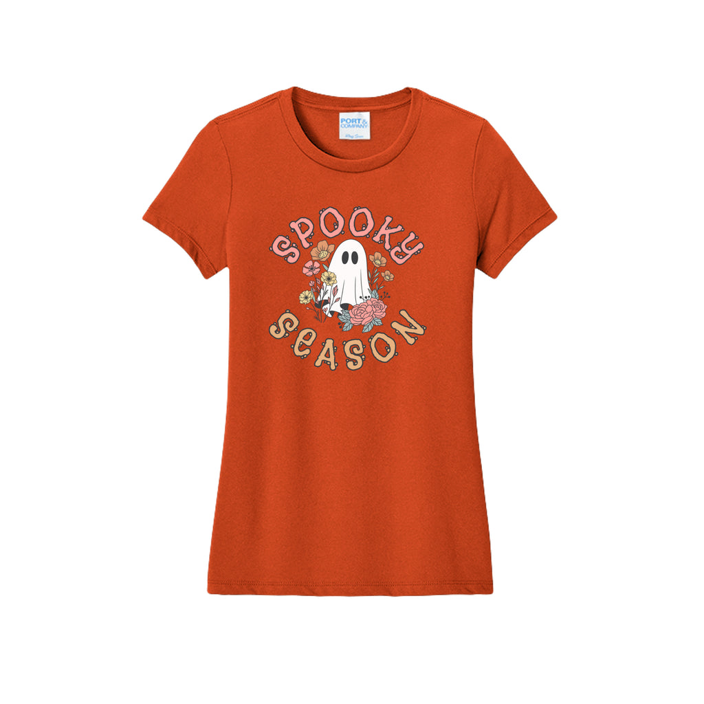 Front view of a orange fitted short-sleeve T-shirt showing Spooky Season lettering around a white ghost surrounded by pink, orange, and yellow flowers.