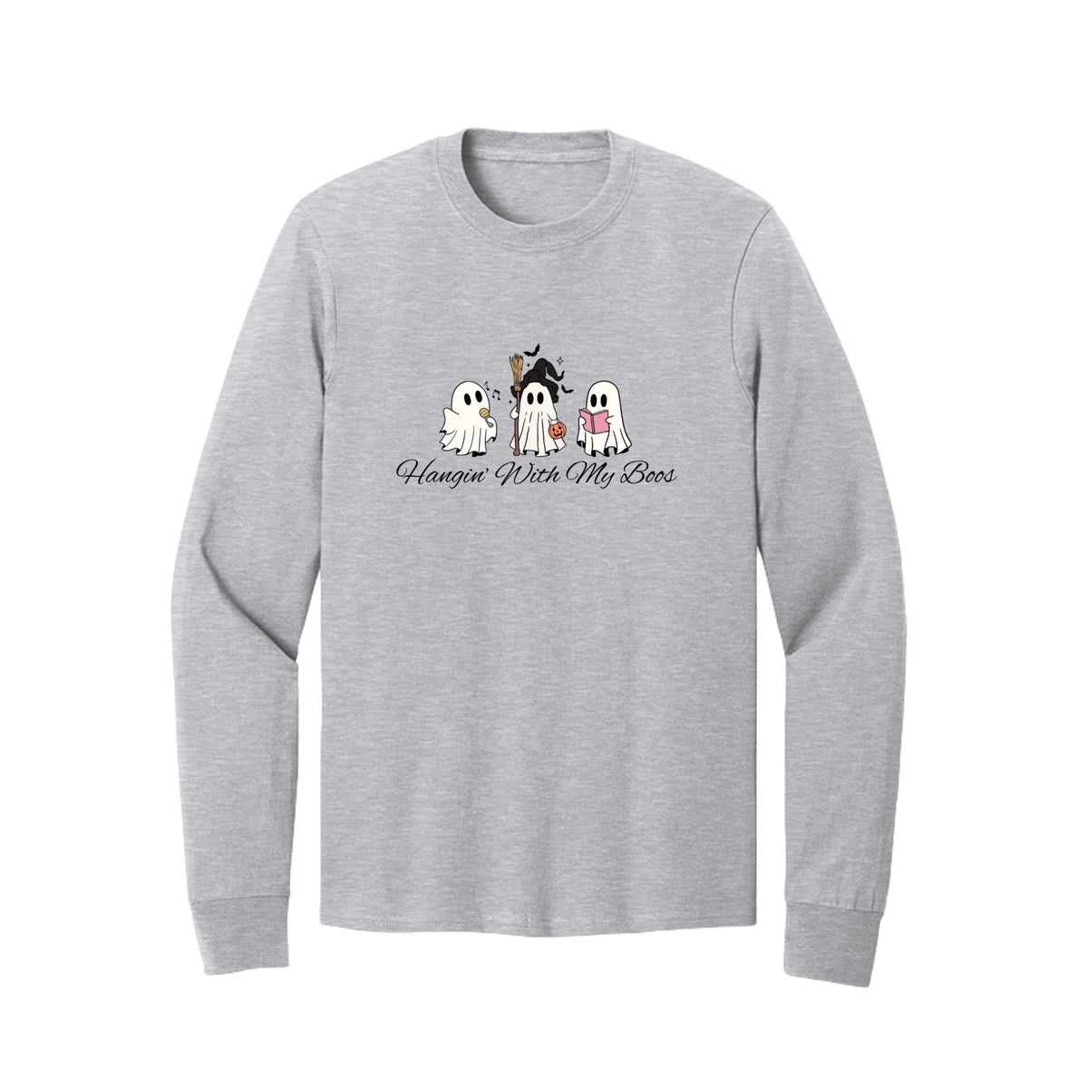 Front view of a long-sleeve T-shirt showing three ghosts with a microphone, witch hat and broom, pumpkin bucket, and pink book.